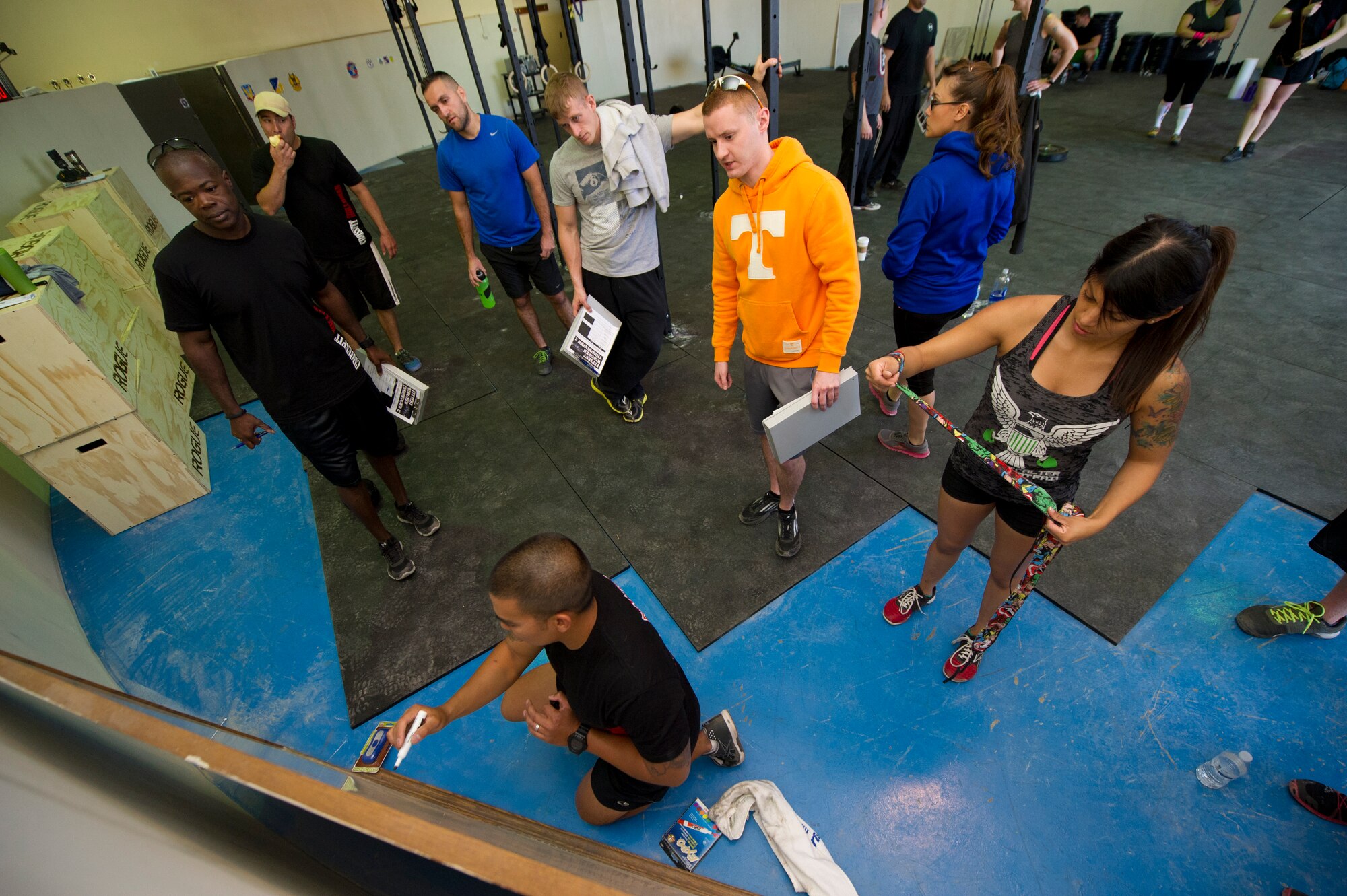 Major Gabe Avilla, 49th Communications Squadron commander and a certified CrossFit instructor, updates a board listing the times and scores of the competitors of the Fittest Wingmen Throwdown 2 at Holloman Air Force Base, N.M., May 16. The Fittest Wingmen Throwdown competition rated Airmen’s performance across various CrossFit exercises to ultimately decide a winning team of more than 20 participants. (U.S. Air Force photo by Airman 1st Class Aaron Montoya / Released)