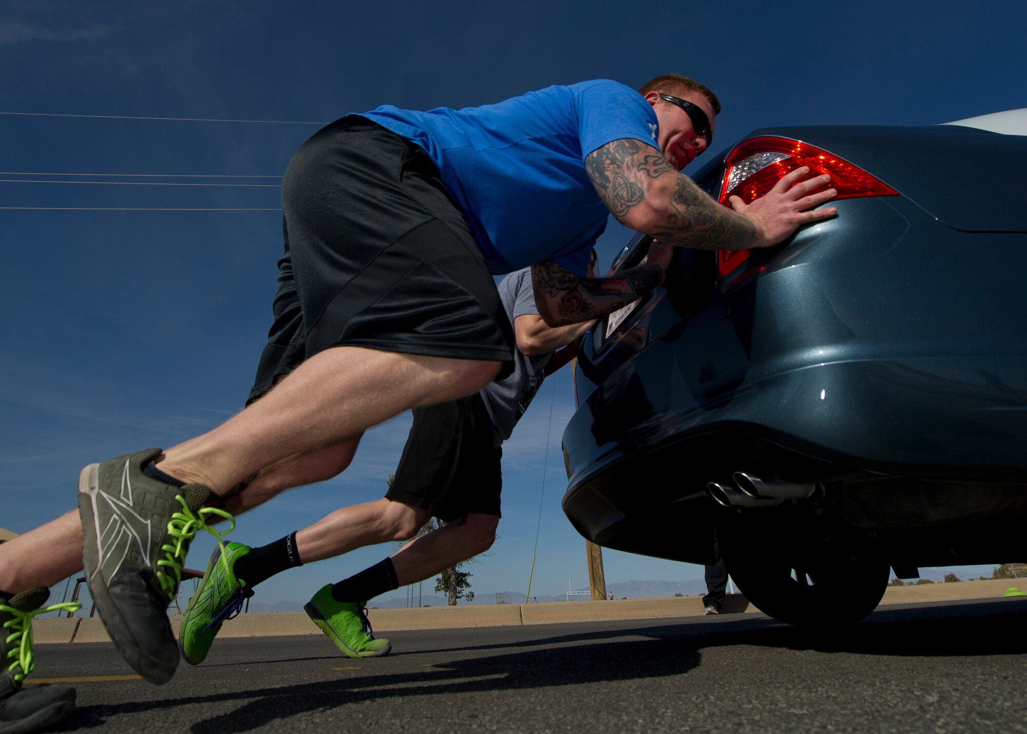Members of Team Holloman participate in a car push even during the Fittest Wingmen Throwdown 2 competition at Holloman Air Force Base, N.M., May 16. The Fittest Wingmen Throwdown competition rated Airmen’s performance across various CrossFit exercises to ultimately decide a winning team of more than 20 participants. (U.S. Air Force photo by Airman 1st Class Aaron Montoya / Released)