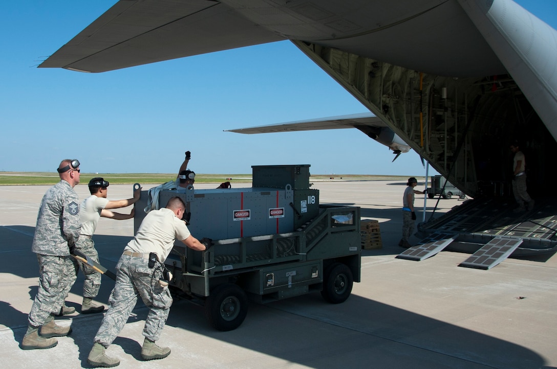 Airmen from Altus Air Force Base, Okla., pitched in to help load and inspect equipment and tools onto a C-130 Hercules supplied by Dyess AFB, Texas, May 11, 2014. Through the help of Dyess and Atlus, members of Sheppard’s own 88th Fighter Training Squadron were able to make the trip down to Florida to provide air-to-air combat simulation presentations for the Florida Air National Guard. The trip provides training to both the FANG and the instructor pilots from Sheppard AFB, Texas. (U.S. Air Force photo/Airman 1st Class Robert L. McIlrath)





 

