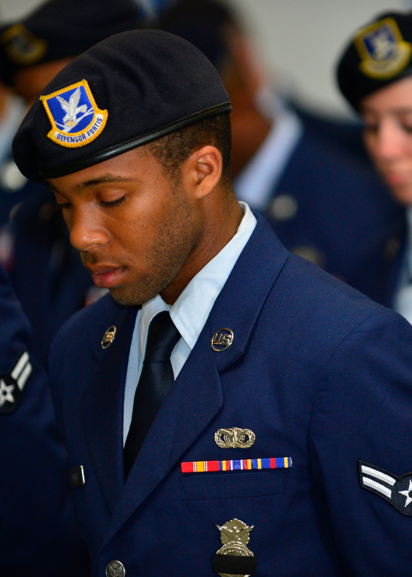 Dexter Turner, 436th Security Force Squadron patrolman, bows his head while a bell is rung for fallen police officers during a retreat ceremony May 16, 2014 at Dover Air Force Base, Del. The retreat ceremony was held to honor fallen police officers during National Police Week. (U.S. Air Force photo/Airman 1st Class William Johnson)