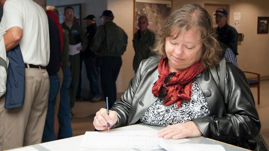 Kay Rudo, wife of Mark Rudo, prior honorary commander, files her and her husband’s flight plan during Dover Air Force Base Mid-Air Collision Avoidance Fly-in May 17, 2014, at airfield management on Dover AFB, Del. The event informed general aviation pilots about the unique airspace and mission Team Dover has and the importance of communication. (U.S. Air Force photo/Senior Airman Jared Duhon)  