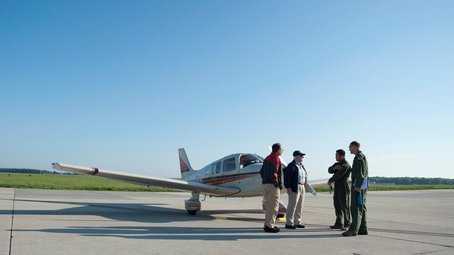 Members of the 436th Airlift Wing Safety Office greet pilots during the Dover Air Force Base Mid-Air Collision Avoidance Fly-in May 17, 2014, at Dover AFB, Del. The event promoted the importance of communications by general aviation pilots to the base. (U.S. Air Force photo/Senior Airman Jared Duhon) 