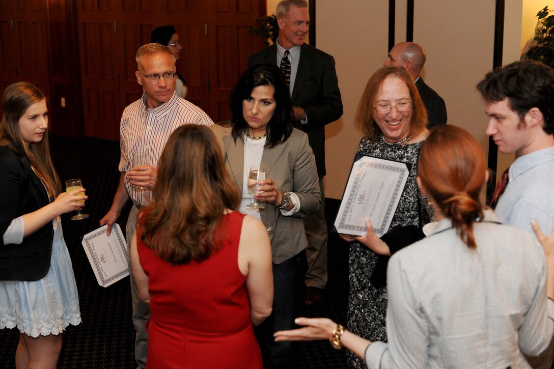 Team Andrews members gather after the Andrews Officers Spouses’ Club scholarship presentation at The Club on Joint Base Andrews, Md., May 17, 2014. Scholarships are awarded to high school seniors, undergraduate students or military spouses who plan to attend an accredited college or university in the fall. (U.S. Air Force photo/Airman 1st Class Ryan J. Sonnier)