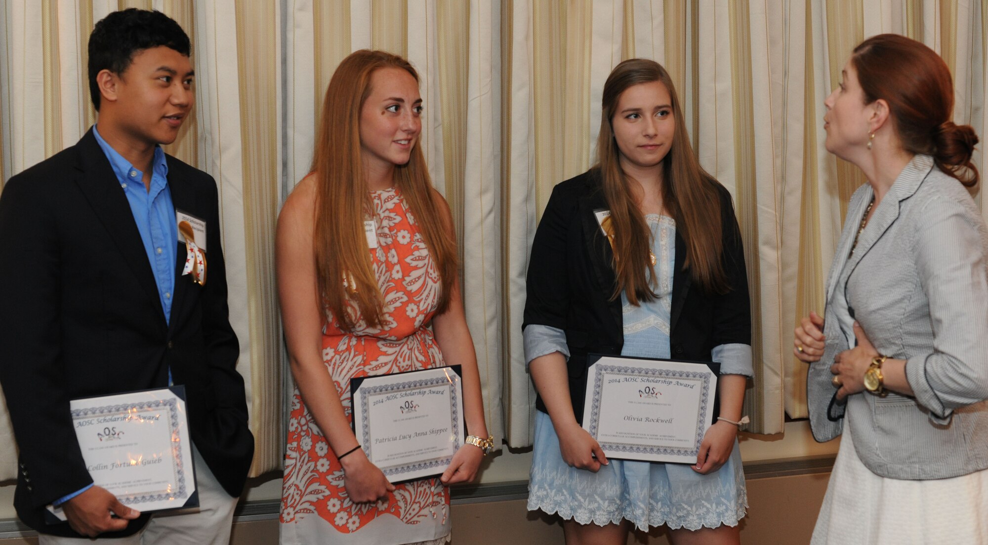 Mandy Huckins, right, speaks with winners after the Andrews Officers Spouses’ Club scholarship presentation at The Club on Joint Base Andrews, Md., May 17, 2014. Huckins is the AOSC scholarship committee chairwoman. (U.S. Air Force photo/Airman 1st Class Ryan J. Sonnier)