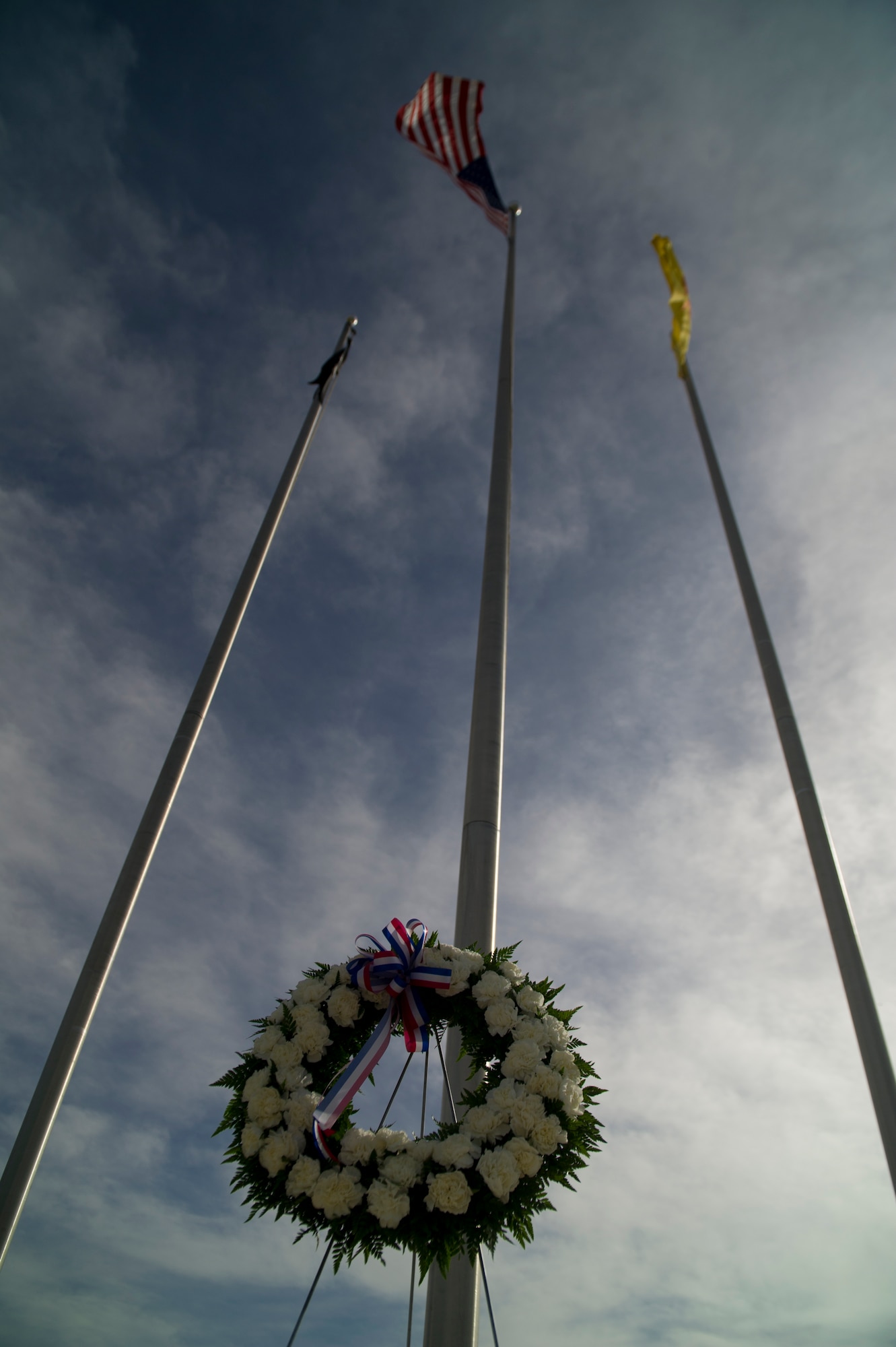 A wreath is displayed below the U.S. flag in honor of fallen law enforcement heroes during the Police Week closing ceremony at Holloman Air Force Base, N.M., May 16. According to the National Police Week website, President John F.  Kennedy signed a proclamation in 1962 that designated May 15 as Peace Officers Memorial Day and the week in which that date falls as National Police Week. Since the inception of National Police Week, the United States Air Force has lost 120 military and civilian law enforcement officers. (U.S. Air Force photo by Airman 1st Class Aaron Montoya / Released)
