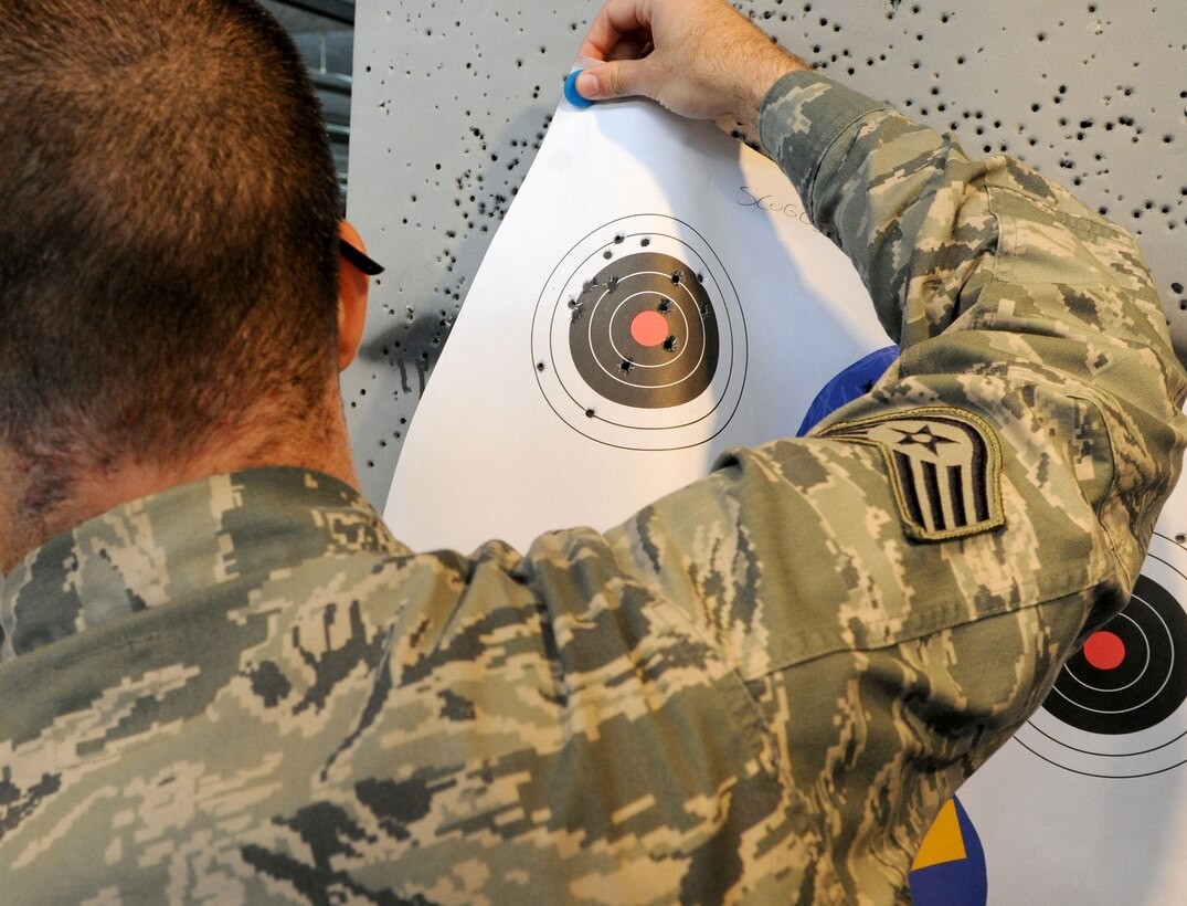 A Staff Sergeant collects his target after a shooting competition held during National Police Week on Joint Base Andrews, Md., May 16, 2014. The event was a way for members to gather and compete in honor of those who have fallen in the line of duty. (U.S. Air Force photo/Airman 1st Class Ryan J. Sonnier)