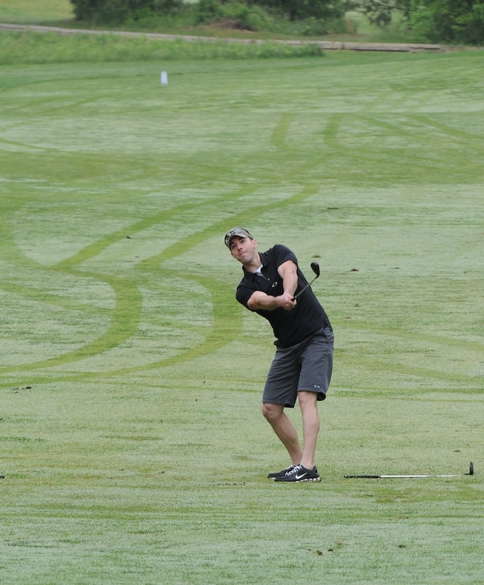 Staff Sgt. Anthony Fair hits a fairway shot to the green during the 5th Annual Security Forces Golf Tournament at The Courses at Andrews on Joint Base Andrews, Md., May 14, 2014.  The tournament was held to raise money for National Police Week. Fair is an 11th Security Forces Squadron elite gate guard. (U.S. Air Force photo/Airman 1st Class Ryan J. Sonnier)