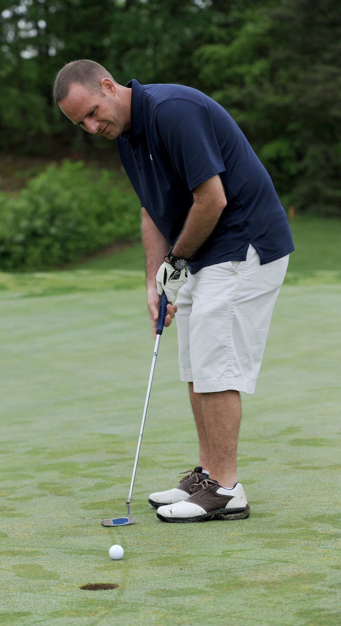 Master Sgt. Justin Wilkerson attempts to sink his putt during the 5th Annual Security Forces Golf Tournament at The Courses at Andrews on Joint Base Andrews, Md., May 14, 2014. The event was held for National Police Week to honor those who have fallen. Wilkerson is the 11th Security Support Squadron’s logistics and readiness NCO in-charge. (U.S. Air Force photo/Airman 1st Class Ryan J. Sonnier)