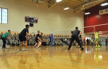 Bob Holmes (far right) scores the winning point in his first match against 341st Missile Wing Airmen at the Malmstrom Air Force Base fitness center on May 16. Holmes single-handedly played and beat five teams to prove his motivational message that it is possible to ‘beat the odds’ through perseverance. (U.S. Air Force photo / John Turner)