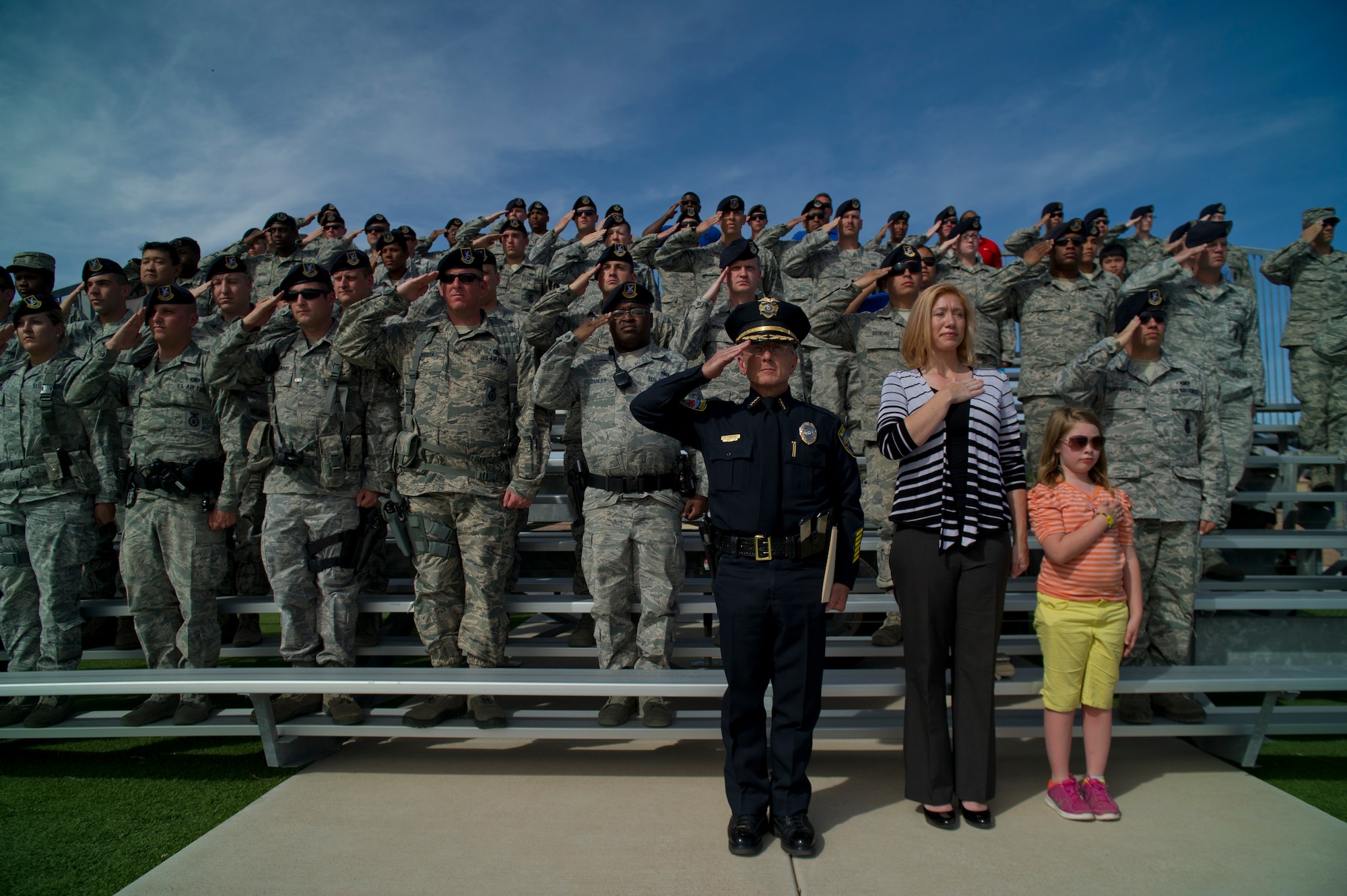 Robert Duncan, Alamogordo chief of police, Susie Galea, Alamogordo mayor, and members of the 49th Security Forces Squadron salute the flag as retreat is played during the Police Week closing ceremony at Holloman Air Force Base, N.M., May 16. According to the National Police Week website, President John F.  Kennedy signed a proclamation in 1962 that designated May 15 as Peace Officers Memorial Day and the week in which that date falls as National Police Week. Since the inception of National Police Week, the United States Air Force has lost 120 military and civilian law enforcement officers. (U.S. Air Force photo by Airman 1st Class Aaron Montoya / Released)