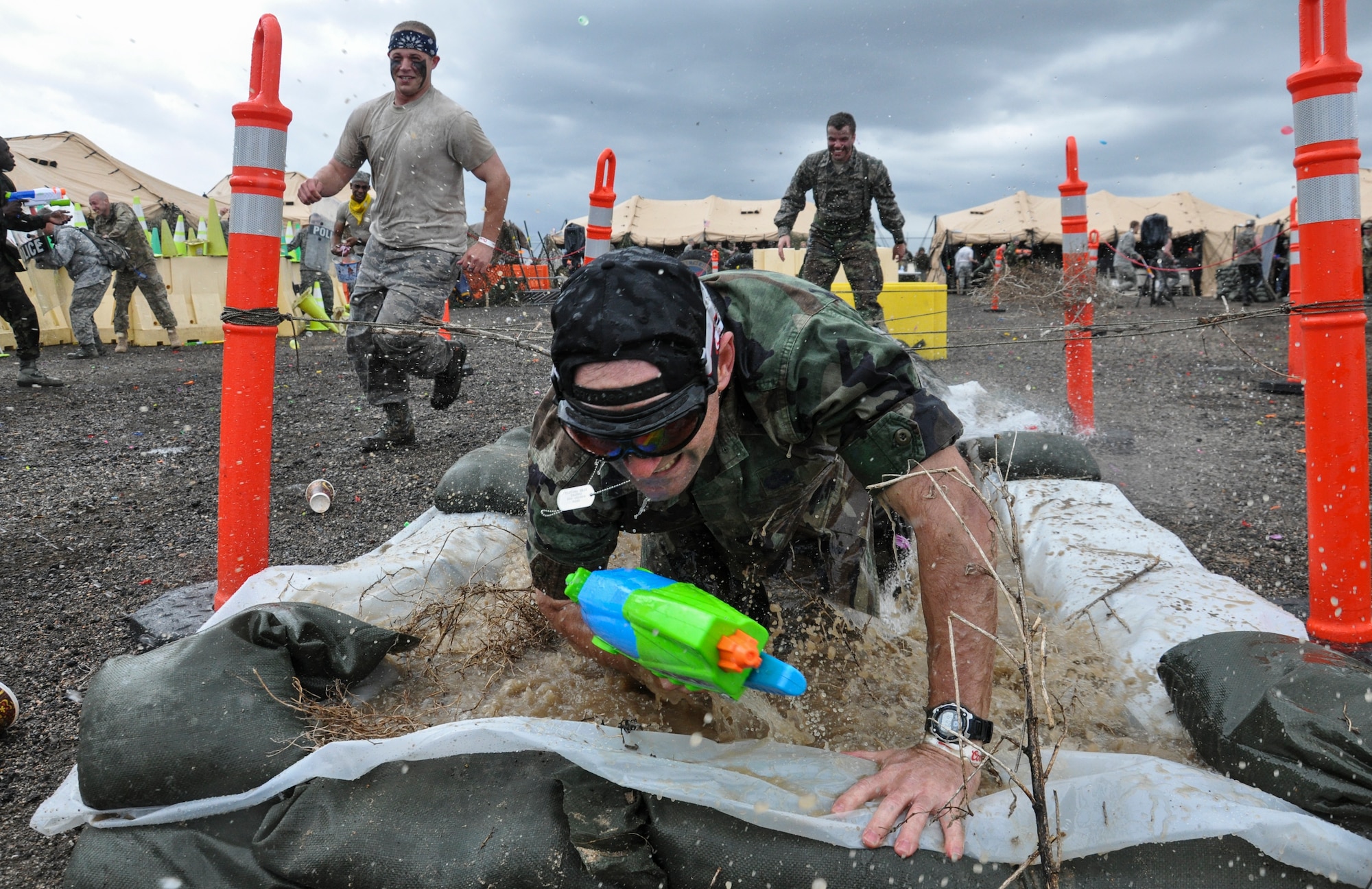 Lt. Col. Hew Wells, 460th Space Communications Squadron commander, navigates the obstacle course on his way to the grog bowl during the Combat Dining Out festivities May 16, 2014, at Camp Rattlesnake on Buckley Air Force Base, Colo. The dining out brought all members of the base together for water battles, an obstacle course, camaraderie and some good, clean fun. (U.S. Air Force photo by Staff Sgt. Nicholas Rau/Released) 