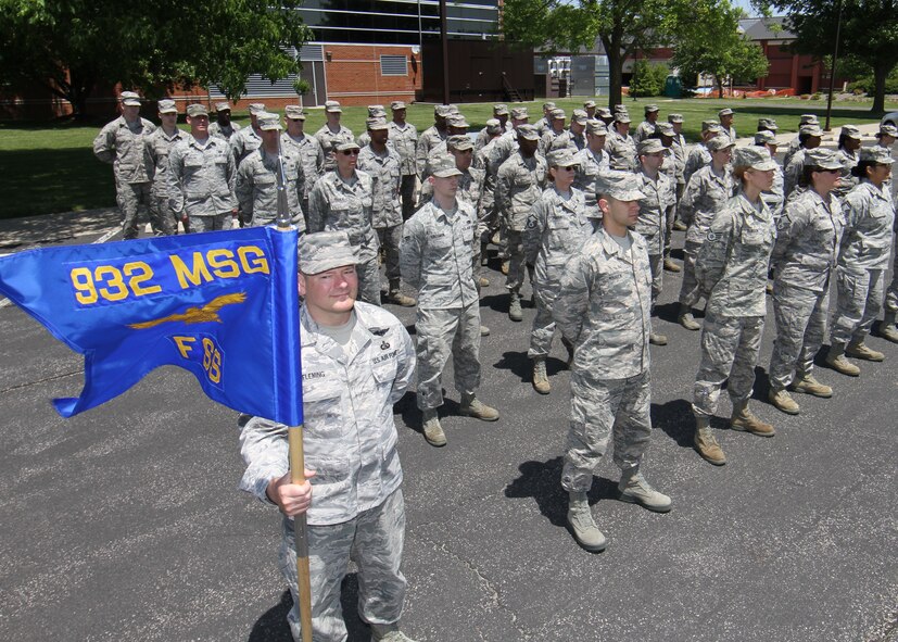 The 932nd Mission Support Group, Force Support Squadron, stands at the ready for an open ranks inspection as Senior Master Sergeant Don Fleming hold the flag steady in a windy area near the unit.  (U.S. Air Force photo/Tech. Sgt. Chris Parr)