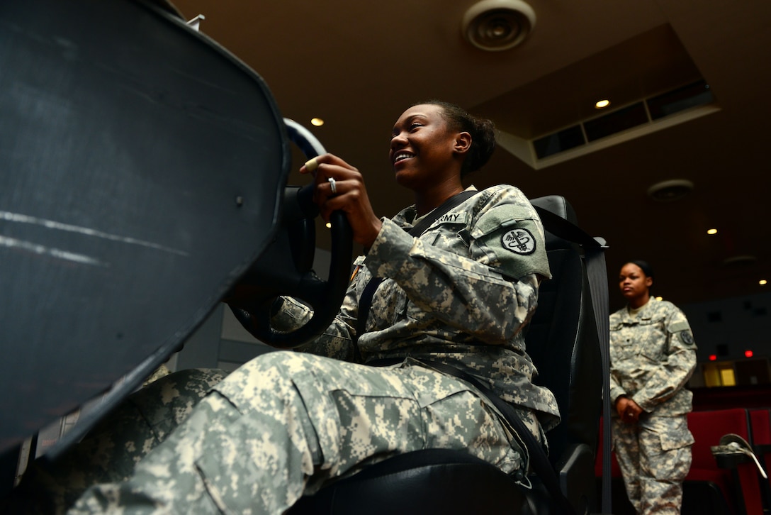 U.S. Army Pvt. Sharione McCrea, Dental Command medical logistics specialist, attempts to drive using the drunk driving simulator during a brief from the Save-a-Life Tour at Fort Eustis, Va., May 19, 2014. Soldiers are required to have four hours of substance abuse training each year. McCrea is from Anchorage, Ala. (U.S. Air Force photo by Airman 1st Class Kimberly Nagle/Released)