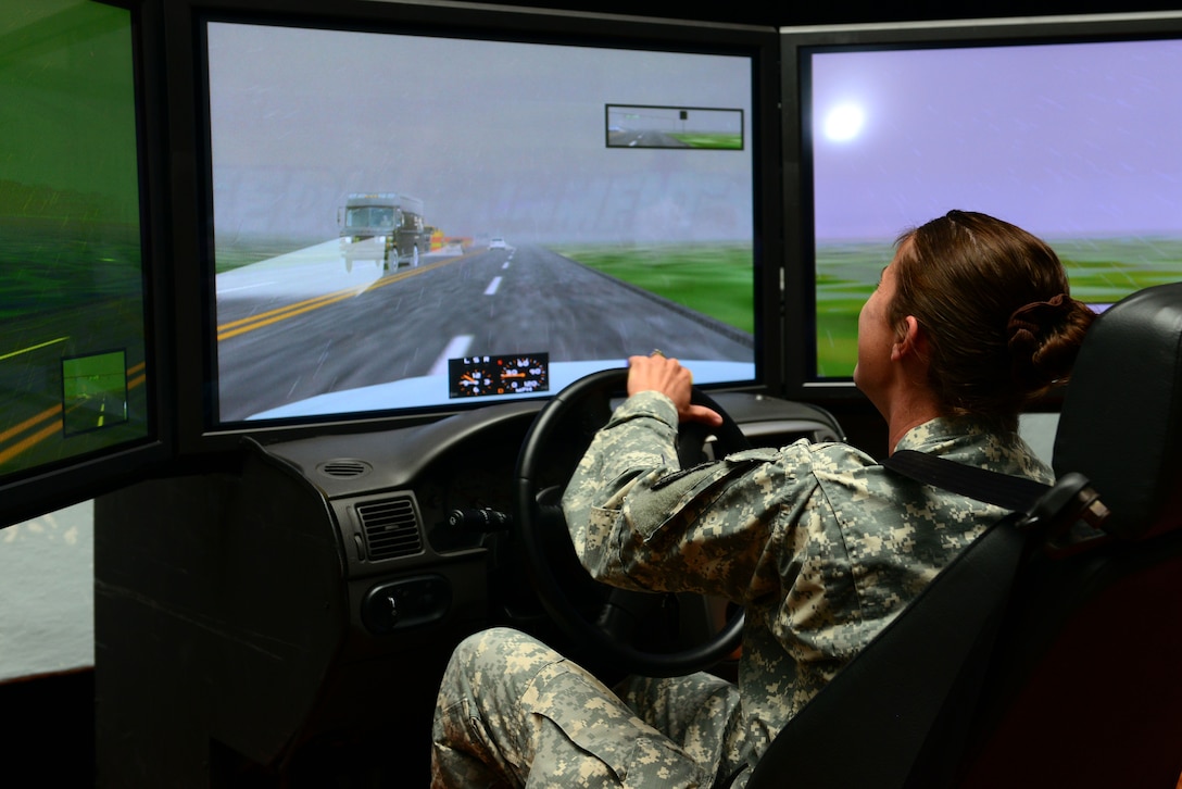U.S. Army Sgt. Stephanie Bozard, Dental Command dental hygienist, tries her hand at a drunk driving simulator during the Save-a-Life Tour brief at Fort Eustis, Va., May 19, 2014. The S.A.L.T is a driving safety program that includes videos, a speaker and simulators. Bozard is from Irmo, S.C. (U.S. Air Force photo by Airman 1st Class Kimberly Nagle/Released)