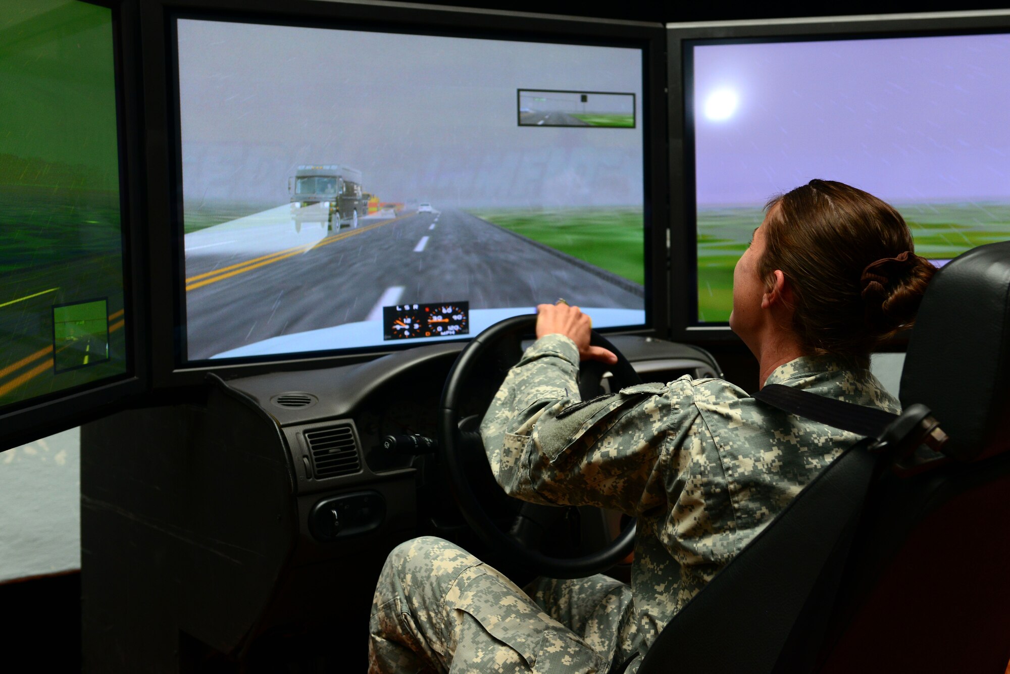 U.S. Army Sgt. Stephanie Bozard, Dental Command dental hygienist, tries her hand at a drunk driving simulator during the Save-a-Life Tour brief at Fort Eustis, Va., May 19, 2014. The S.A.L.T is a driving safety program that includes videos, a speaker and simulators. Bozard is from Irmo, S.C. (U.S. Air Force photo by Airman 1st Class Kimberly Nagle/Released)
