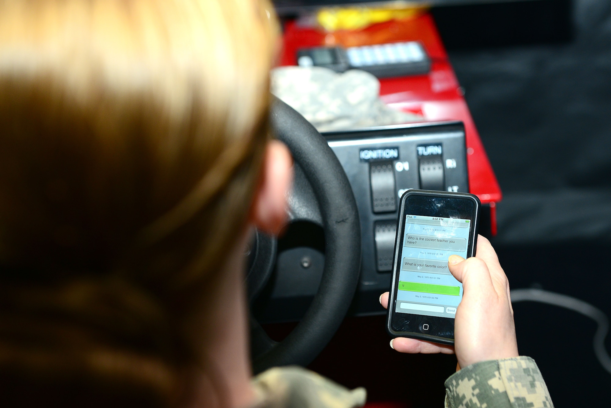 U.S. Army Sgt. 1st Class Jennifer King , Dental Command operations non-commissioned officer, attempts to text and drive on a simulator during a brief at Fort Eustis, Va., May 19, 2014. The Save-a-Life Tour educated Soldiers on the importance of not texting or drinking and driving. King is from Sierra Vista, Ariz. (U.S. Air Force photo by Airman 1st Class Kimberly Nagle/Released)