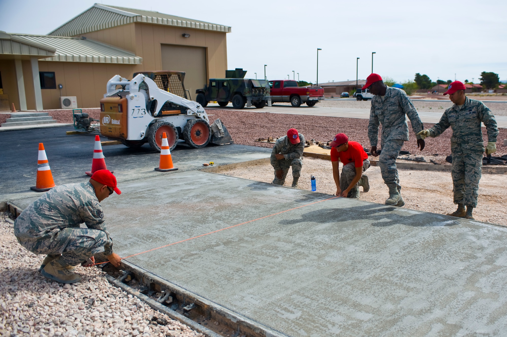 Airmen from the 820th RED HORSE work on a cement walkway May 15, 2014 at Nellis Air Force Base. The new fire station for housing is planned to be complete July 1 and is going to be operational by July 15. (U.S. Air Force photo by Airman 1st Class Jake Carter)