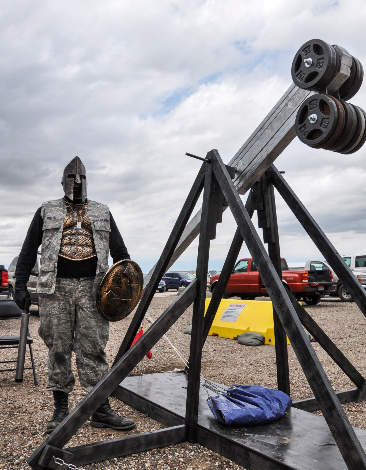 An Airman shows off his modified uniform next to his water balloon catapult before the Combat Dining Out festivities kick off May 16, 2014, at Camp Rattlesnake on Buckley Air Force Base, Colo. The dining out brought all members of the base together for water battles, an obstacle course, camaraderie and some good, clean fun. (U.S. Air Force photo by Staff Sgt. Nicholas Rau/Released) 