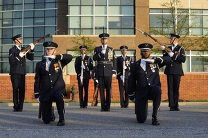 The USAF Honor Guard drill team performs during the Joint Base Andrews Heritage Park Concert, May 17, 2014. The free concert included a performance by Max Impact, the premier rock band of the Air Force, a UH-1N Huey Helicopter display and an explosive ordnance bomb disposal robot. (U.S. Air Force photo/Senior Airman Mariah Haddenham)