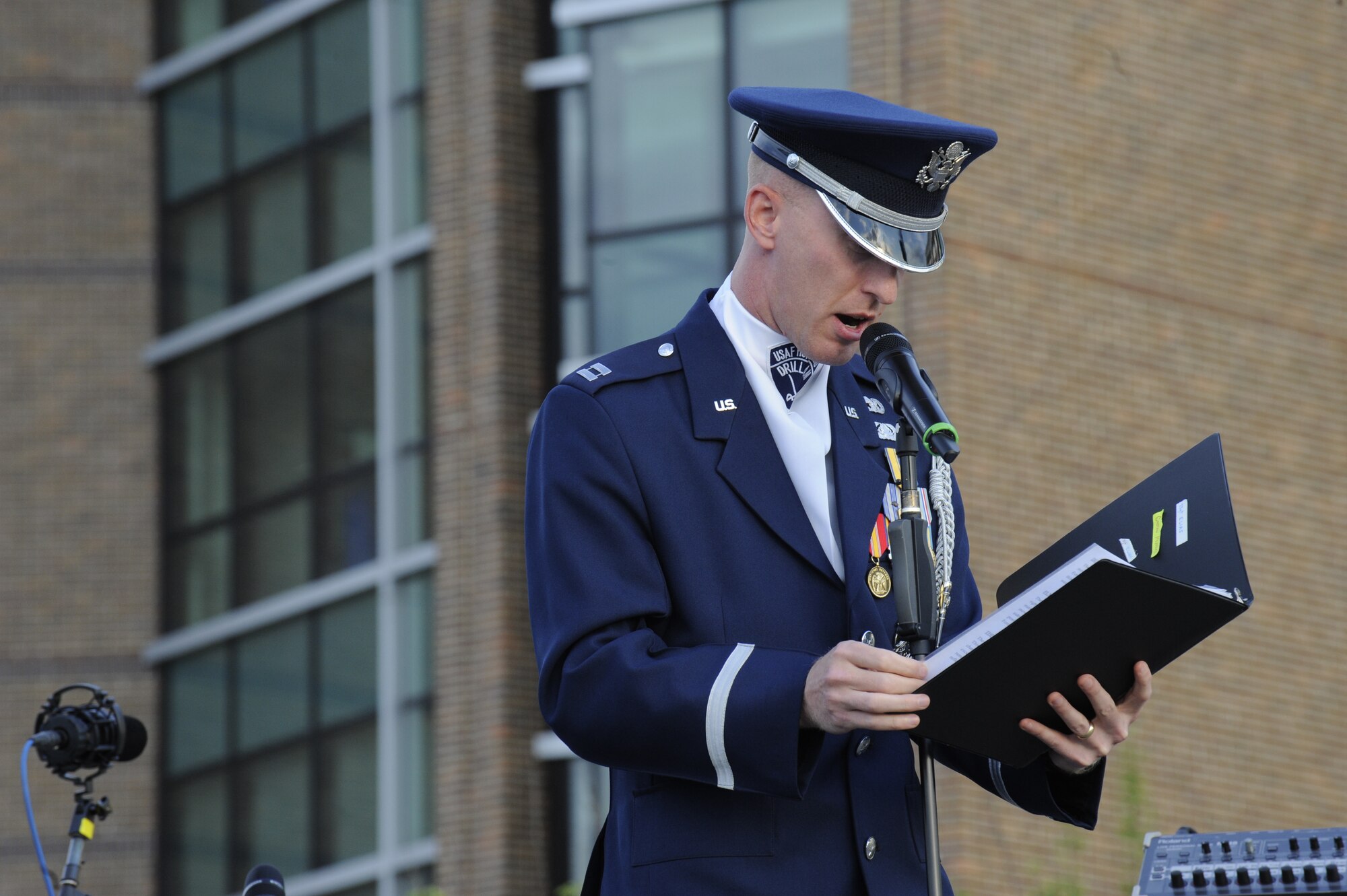 Capt. Alan Morford, USAF Honor Guard drill team commander, gives opening remarks prior to the Air Force Honor Guard drill team performance during the Joint Base Andrews Heritage Park Concert, May 17, 2014. The free concert included a performance by Max Impact, the premier rock band of the Air Force, a UH-1N Huey Helicopter display and an explosive ordnance bomb disposal robot. (U.S. Air Force photo/Senior Airman Mariah Haddenham)