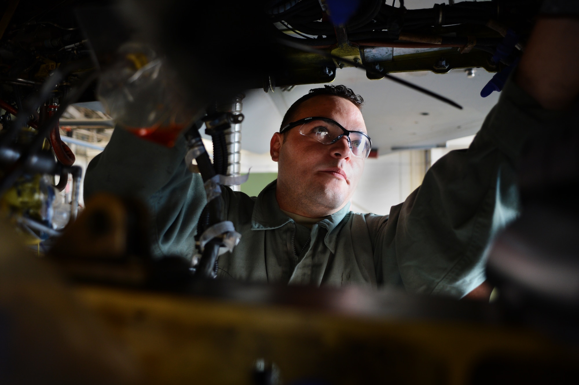 U.S. Air Force Staff Sgt. Joseph Gallegos, 309th Aircraft Maintenance Group aircraft structural maintenance technician, assigned to Hill Air Force Base, Utah, inspects the bulkhead of an F-16CJ Fighting Falcon at Shaw AFB, S.C., May 20, 2014. Gallegos and his team will spend the next month and a half removing the existing bulkhead and installing a new one on the aircraft. (U.S. Air Force photo by Airman 1st Class Jonathan Bass/Released)