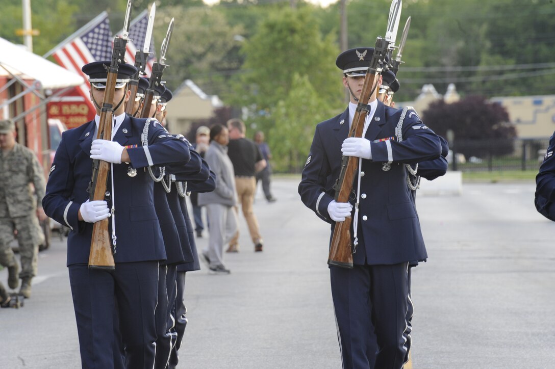 The USAF Honor Guard drill team performs during the Joint Base Andrews Heritage Park Concert, May 17, 2014. The free concert included a performance by Max Impact, the premier rock band of the Air Force, a UH-1N Huey Helicopter display and an explosive ordnance bomb disposal robot. (U.S. Air Force photo /Senior Airman Mariah Haddenham)
