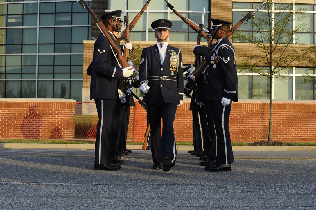The USAF Honor Guard drill team performs during the Joint Base Andrews Heritage Park Concert, May 17, 2014. The free concert included a performance by Max Impact, the premier rock band of the Air Force, a UH-1N Huey Helicopter display and an explosive ordnance bomb disposal robot. (U.S. Air Force photo /Senior Airman Mariah Haddenham)