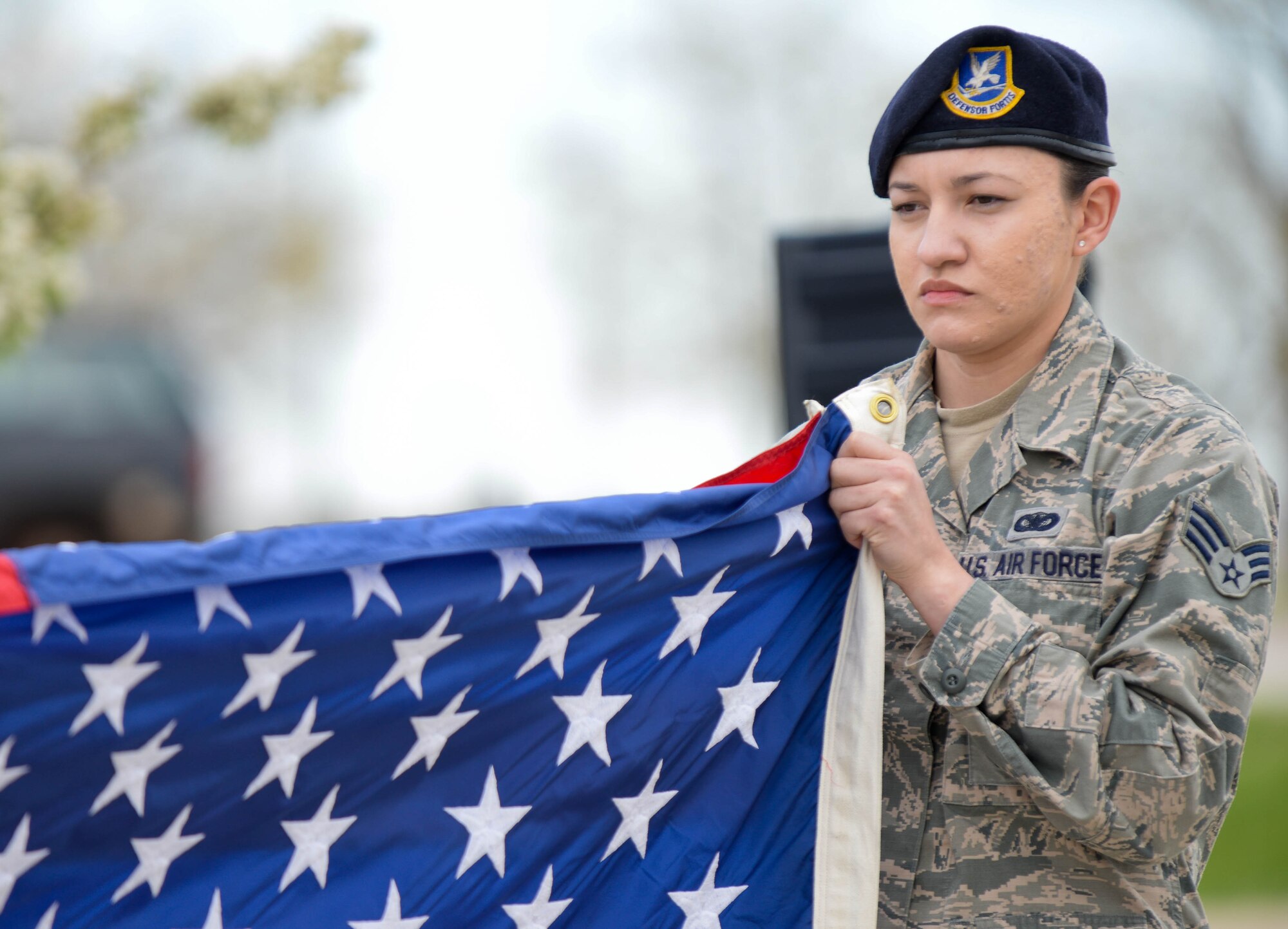 Senior Airman Amaris Serrano, 28th Security Forces Squadron defender, performs a flag folding ceremony during a Police Week retreat ceremony on Ellsworth Air Force Base, S.D., May 15, 2014. Events throughout the week helped people learn more about law enforcement professionals and provided an opportunity to honor past and present police officers. (U.S. Air Force photo by Senior Airman Zachary Hada/Released)