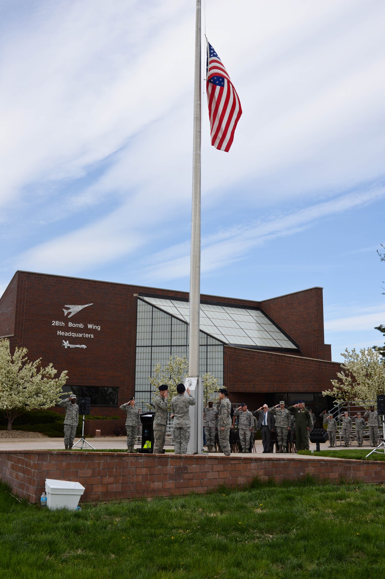 Airmen of the 28th Security Forces Squadron salute the flag during a Police Week retreat ceremony on Ellsworth Air Force Base, S.D., May 15, 2014. National Peace Officers Memorial Day, celebrated every year on May 15, demonstrates to relatives, friends and colleagues of fallen officers that their sacrifices are never forgotten. (U.S. Air Force photo by Senior Airman Zachary Hada/Released)