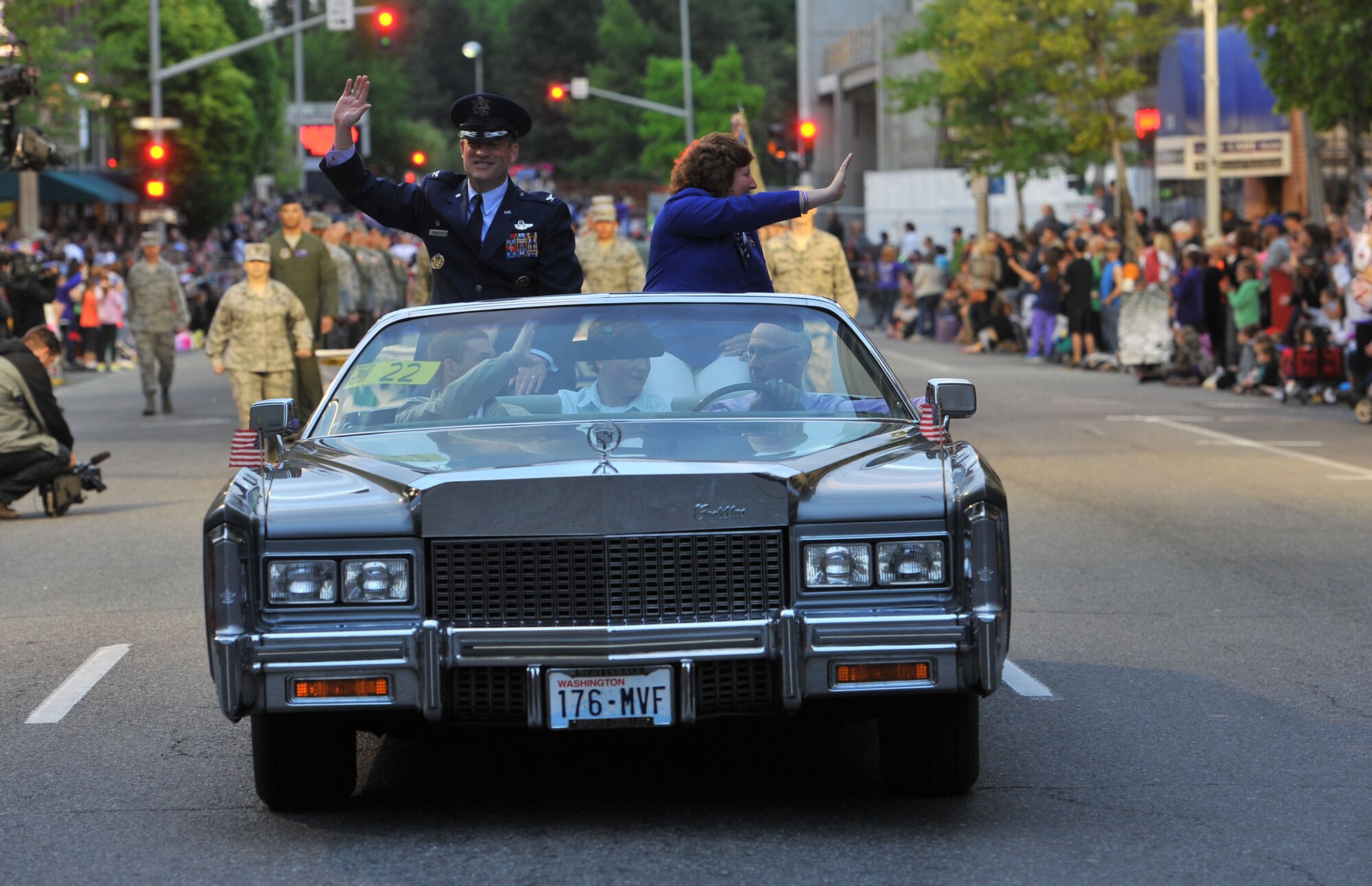 Col. Brian Newberry and his wife, Jill, represent Team Fairchild during the Lilac Festival 2014 Armed Forced Torchlight Parade in Spokane Wash., May 17, 2014. The 75-year-old tradition is made to honor service members of both the past and present. Newberry is the 92nd Air Refueling Wing commander. (U.S. Air Force photo by Staff Sgt. Veronica Montes/Released) 