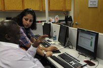 Jessie Mues, 690 Network Support Squadron information specialist Joint Base San Antonio- Lackland Kelly Field Annex (left) assists Kenneth Walker, Air Force Personnel Center safety career field administrator (right) with questions he has in regards to the new Virtual Enterprise Service Desk application. The product, also known as vESD, is a client-based application that serves as a communication platform between the Enterprise Service Desk and all 850 thousand plus users in the Air Force network. Currently, the product is going through a trial period and is expected to be released in October 2014. (U.S. Air Force photo/ Senior Airman Lynsie Nichols)