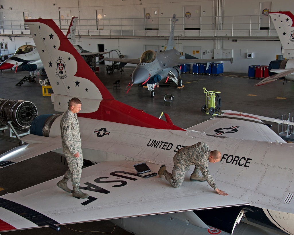 U.S. Air Force Tech Sgt. Vann Pennington instructs and observes Airman 1st Class Eric Weishuhn, 362nd Training Squadron, on the proper inspection of an F-16 Thunderbird aircraft, on May 16, 2014 at Sheppard Air Force Base, Texas. They are part of the F-16 Crew Chief course. (U.S. Air Force photo by Frank Carter/Released)
