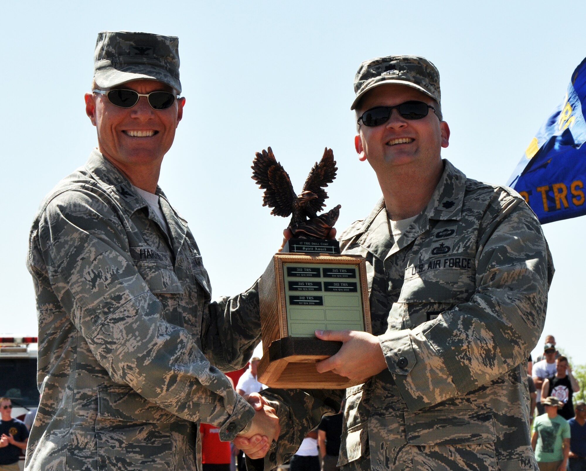 GOODFELLOW AIR FORCE BASE, Texas – Col. Brendan M. Harris, 17th Training Group Commander, presents Lt. Col. Max E. Pearson, 316th Training Squadron Commander, with the Spirit Award at the 17th TRG’s second quarter drill competition on the flight line here May 10. The 315th Training Squadron also won a trophy for the overall competition. (U.S. Air Force photo/ Senior Airman Joshua Edwards)