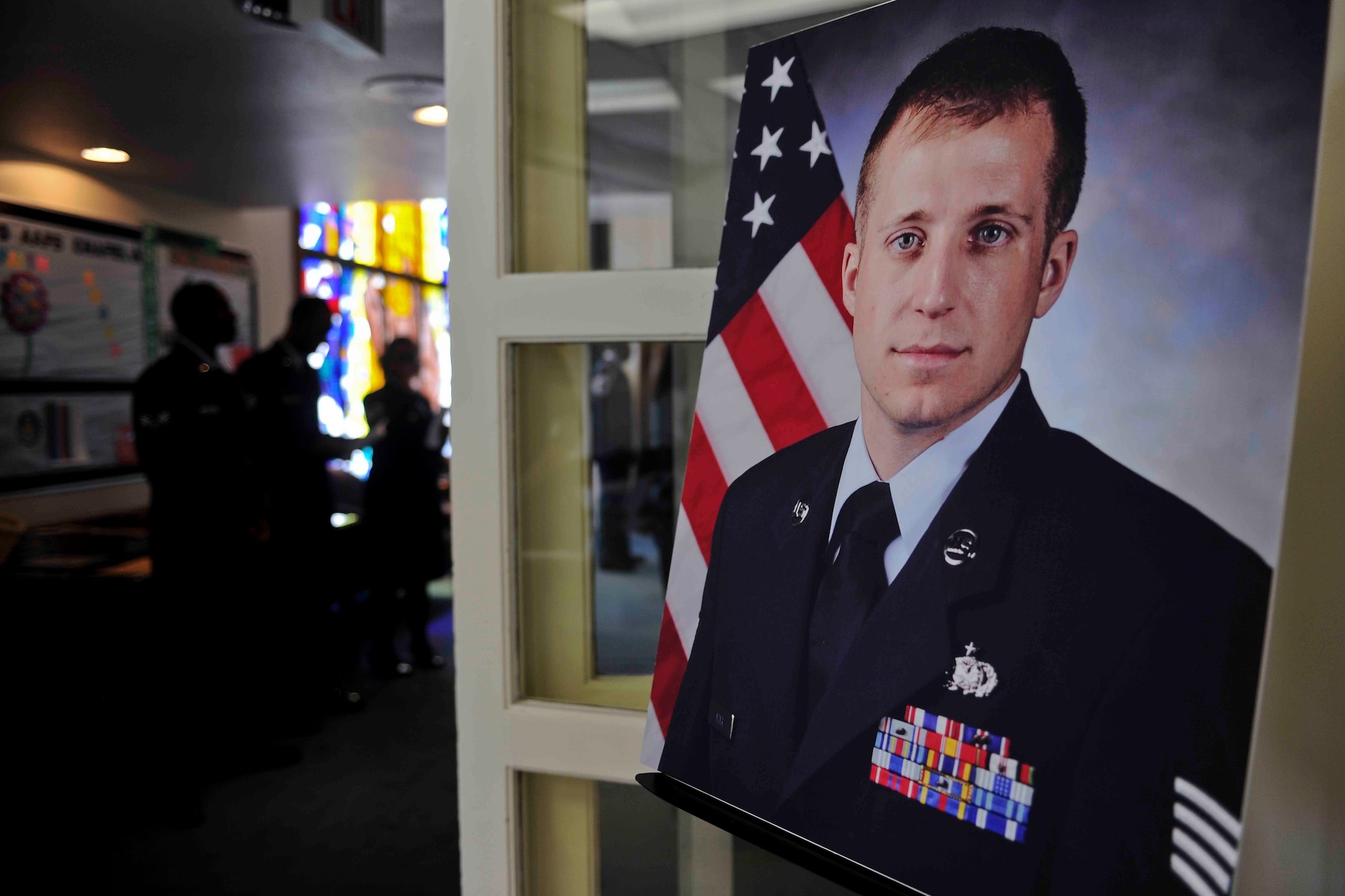 ALTUS AIR FORCE BASE, Okla. – Members of the 97th Air Mobility Wing hold memorial service for U.S. Air Force Staff Sgt. Tedd Adair, 97th Logistics Readiness Squadron hazardous material section supervisor, at the base chapel May 19, 2014. More than 150 Airmen and their families filled the base chapel in remembrance of Adair, who passed away May 10 after being diagnosed with cancer. He is survived by his father Jack, mother Deborah, brother Todd, sister Kerri, son Wyatt and daughter Trinity. (U.S. Air Force photo by Senior Airman Jesse Lopez/Released)
