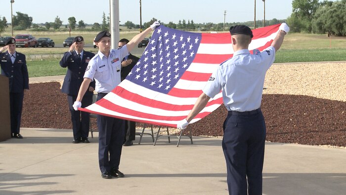 9th Security forces Squadron members fold an American Flag during a National Police Week memorial ceremony at Beale Air Force Base, Calif., May 15, 2014. National Police week is held every May to recognize the service and sacrifice of law enforcement officers. (U.S. Air Force photo by Tech Sgt. Catherine Carbullido White/Released) 