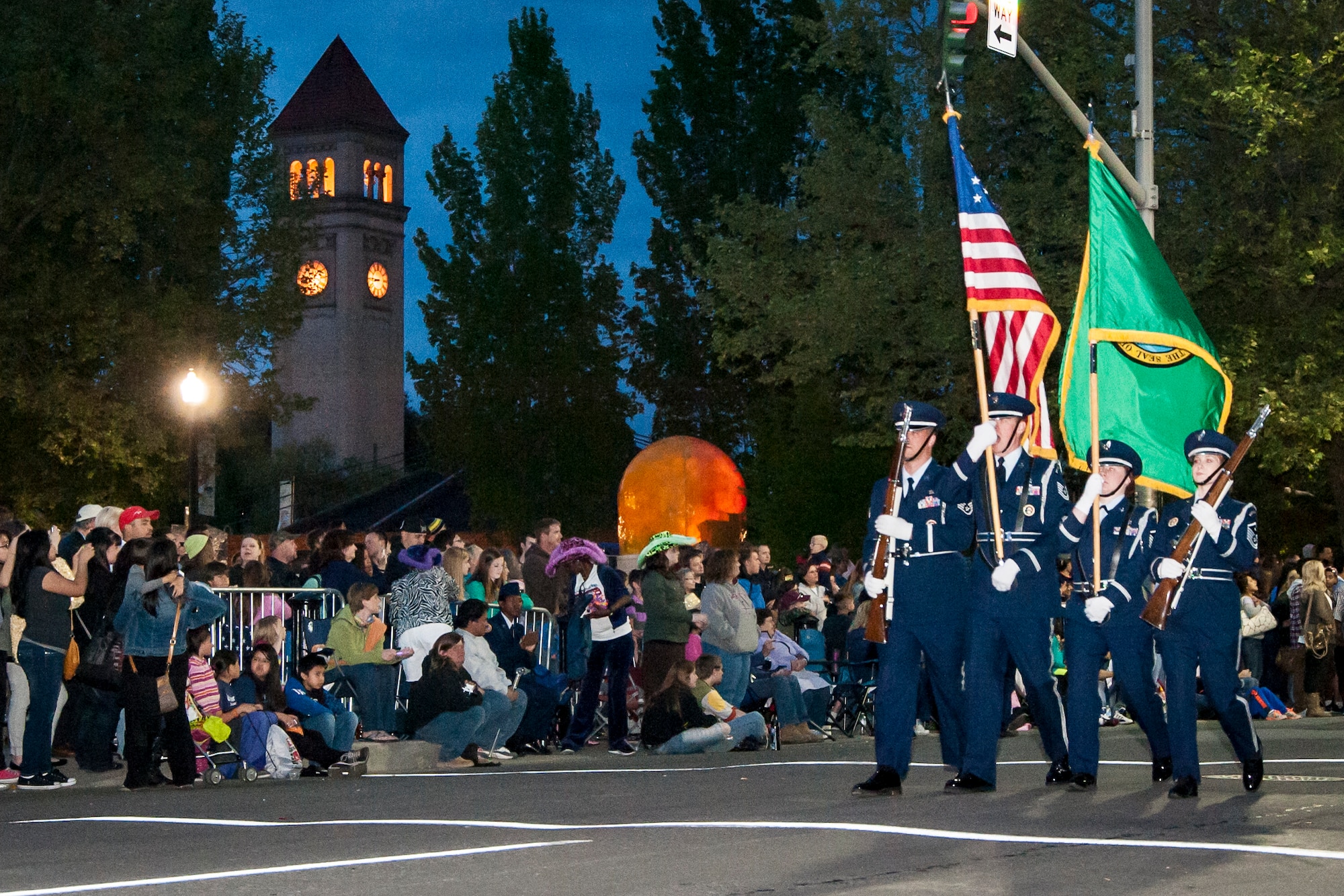 A Fairchild color guard marches as part of the 75th Annual Lilac Festival Armed Forced Torchlight Parade in Spokane, Wash., May 17, 2014. The parade is the largest armed forces torchlight parade in the nation and is made to honor service members of both the past and present. (U.S. Air Force photo by Staff Sgt. Benjamin W. Stratton/Released)