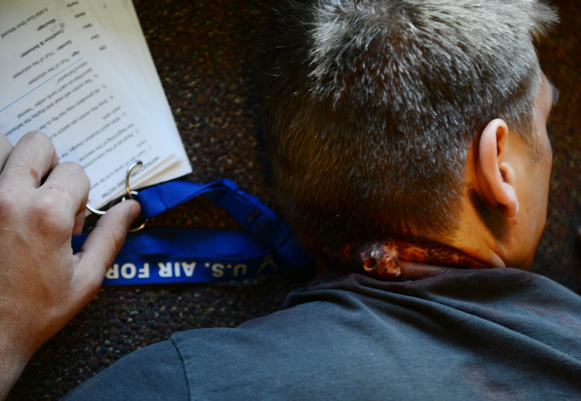 MOODY AIR FORCE BASE, Ga. – A victim lies face down in the base education office during an active shooter exercise at Moody Air Force Base, Ga., May 16, 2014. Moulage, a mold used to create realistic wounds to maximize medical training, was applied to the victim’s neck to mimic a gunshot wound. (U.S. Air Force photo by Senior Airman Tiffany M. Grigg/Released)