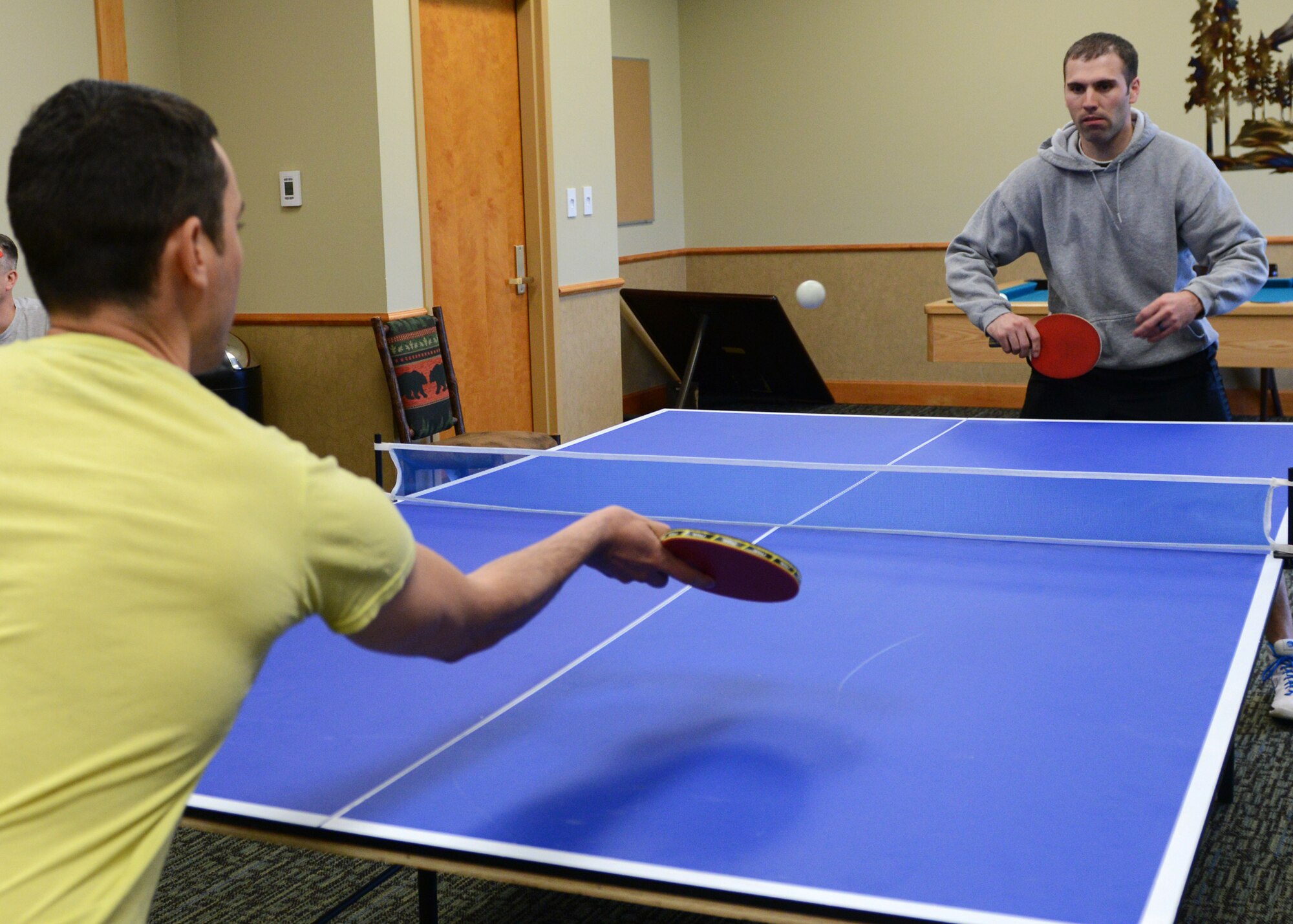 Capt. David Dayton, 341st Missile Wing Judge Advocate (right), and Staff Sgt. Jonathan Sandoval-Barba, 341st Civil Engineer Squadron member, play ping pong during Wing Sports Smackdown on May 16. The Big Sky Top 3 Association hosted the first WSS of the year. (U.S. Air Force photo/Senior Airman Katrina Heikkinen) 