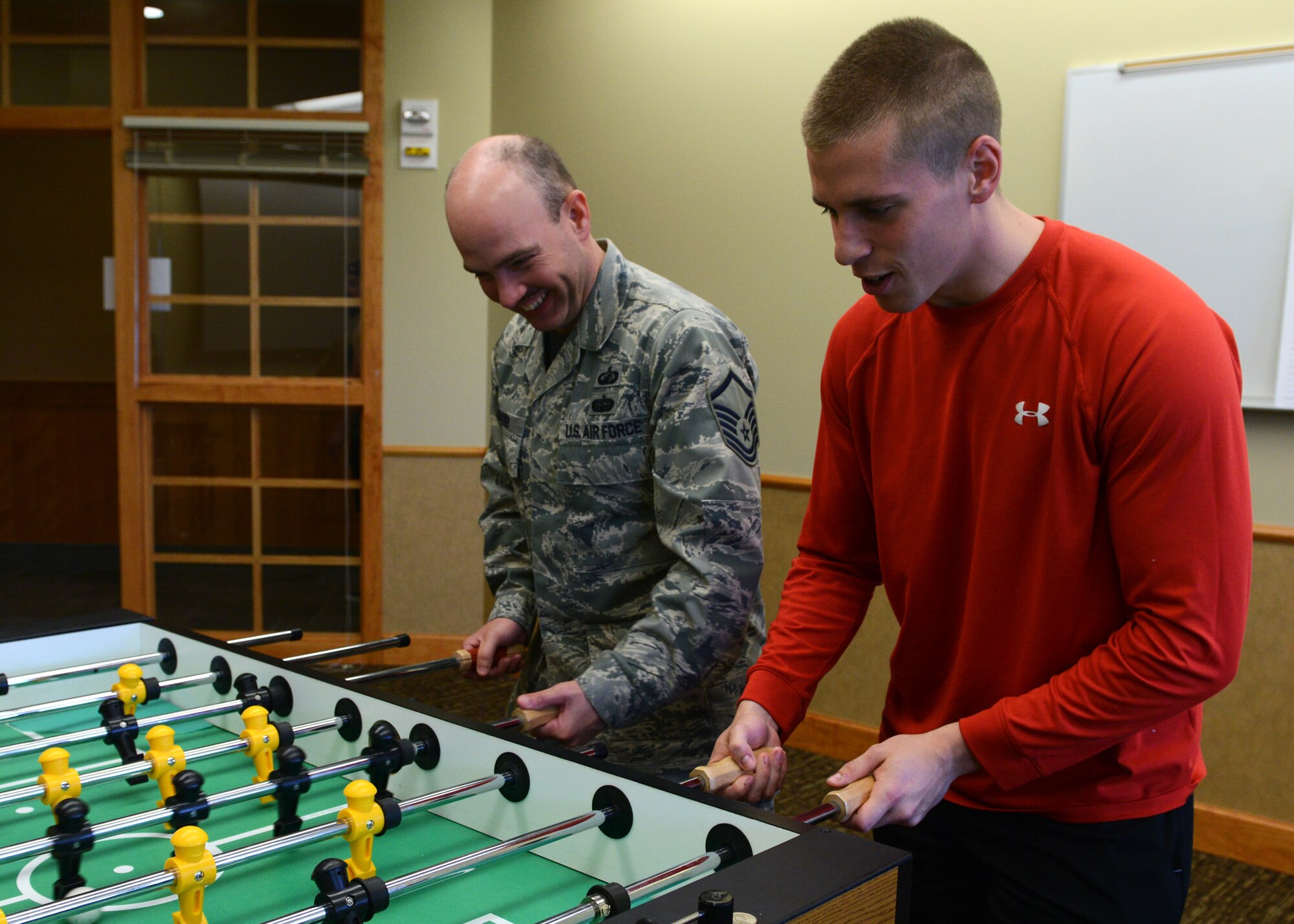 Master Sgt. Jason Tyree, 341st Contracting Squadron superintendent (left), and Airman 1st Class Brett Duffey, 341st CONS specialist, play a game of foosball during Wing Sports Smackdown at the Grizzly Bend on May 16. WSS in conjunction with Wingman Day at Malmstrom Air Force Base. (U.S. Air Force photo/Senior Airman Katrina Heikkinen)