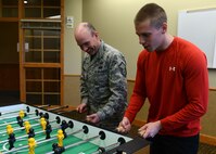 Master Sgt. Jason Tyree, 341st Contracting Squadron superintendent (left), and Airman 1st Class Brett Duffey, 341st CONS specialist, play a game of foosball during Wing Sports Smackdown at the Grizzly Bend on May 16. WSS in conjunction with Wingman Day at Malmstrom Air Force Base. (U.S. Air Force photo/Senior Airman Katrina Heikkinen)