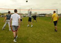 Members of the 341st Contracting Squadron spike a ball over the net during a volleyball game against members from the 341st Civil Engineer Squadron Explosive Ordnance during Wing Sports Smackdown on May 16. The 341st CONS won the game with a score of 15-7. (U.S. Air Force photo/Senior Airman Katrina Heikkinen)