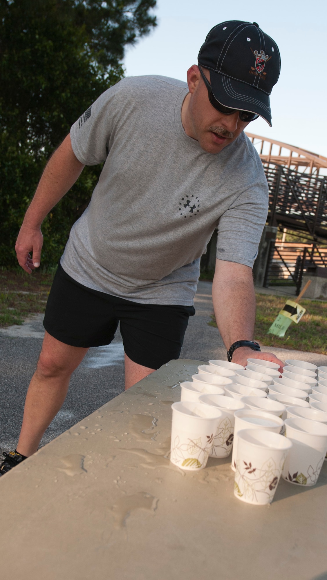 A  runner grabs a cup of water during the 12th Annual Commando 5K Run at Hurlburt Field Fla., May 16, 2014. Volunteers signed runners in,  acted as road guards  and manned water booths. (U.S. Air Force photo/Senior Airman Krystal M. Garrett) 