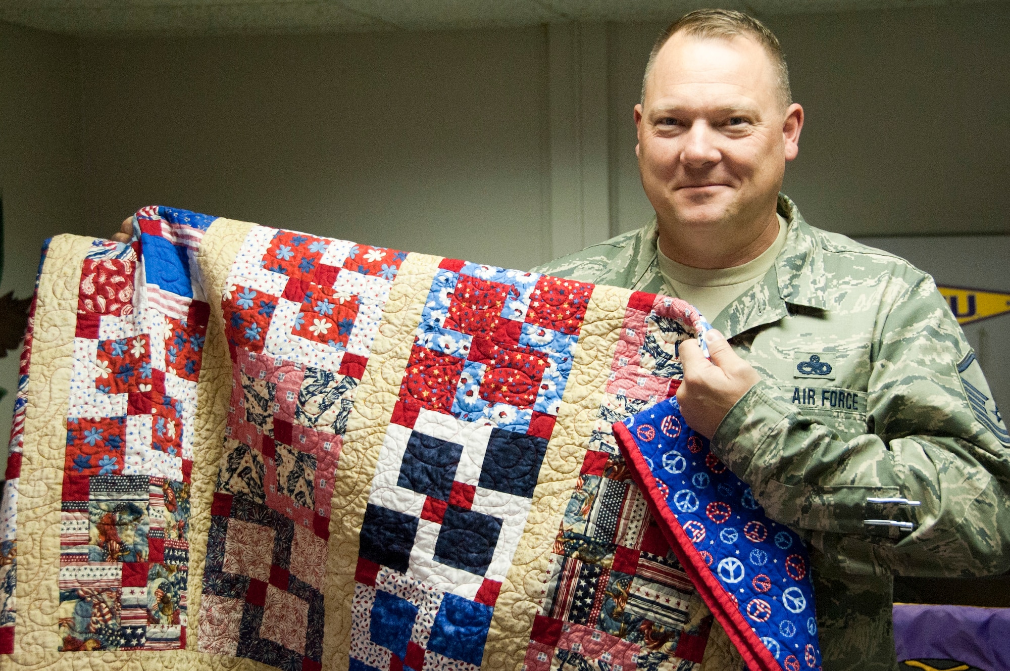 Master Sgt. Brian Booze, 373rd Training Squadron operations manager, was presented a Quilt of Valor by his family May 14, 2014, at Sheppard Air Force Base, Texas. The Quilts of Valor Foundation is a nonprofit, national organization that hand-make quilts to be presented to service members and veterans who have experienced war. Booze has deploy six times in his 20-year career to locations such as Iraq, Afghanistan and Kuwait. (U.S. Air Force photo/Airman 1st Class Robert L. McIlrath)