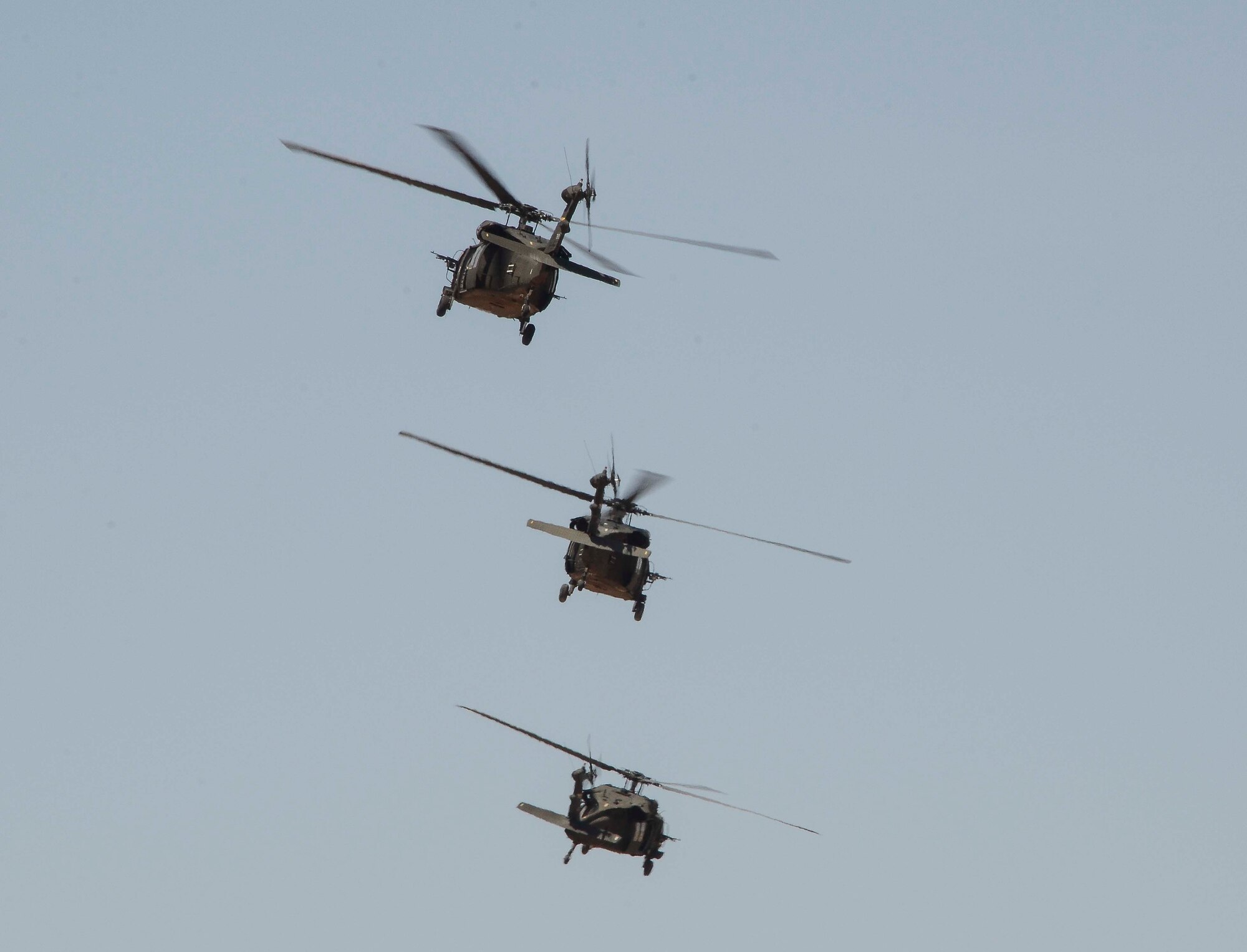 Three Arizona Army National Guard 2-285 UH-60 Black Hawk helicopters depart after off -loading personnel during a training mission in Exercise ANGEL THUNDER on May 14, 2014 at the Florence Military Reservation, Ariz. ANGEL THUNDER 2014 is the largest and most realistic joint service, multinational, interagency combat search and rescue exercise designed to provide training for personnel recovery assets using a variety of scenarios to simulate deployment conditions and contingencies. Personnel recovery forces will train through the full spectrum of personnel recovery capabilities with ground recovery personnel, air assets, and interagency teams. (U.S. Air Force photo by Staff Sgt. Adam Grant/Released)