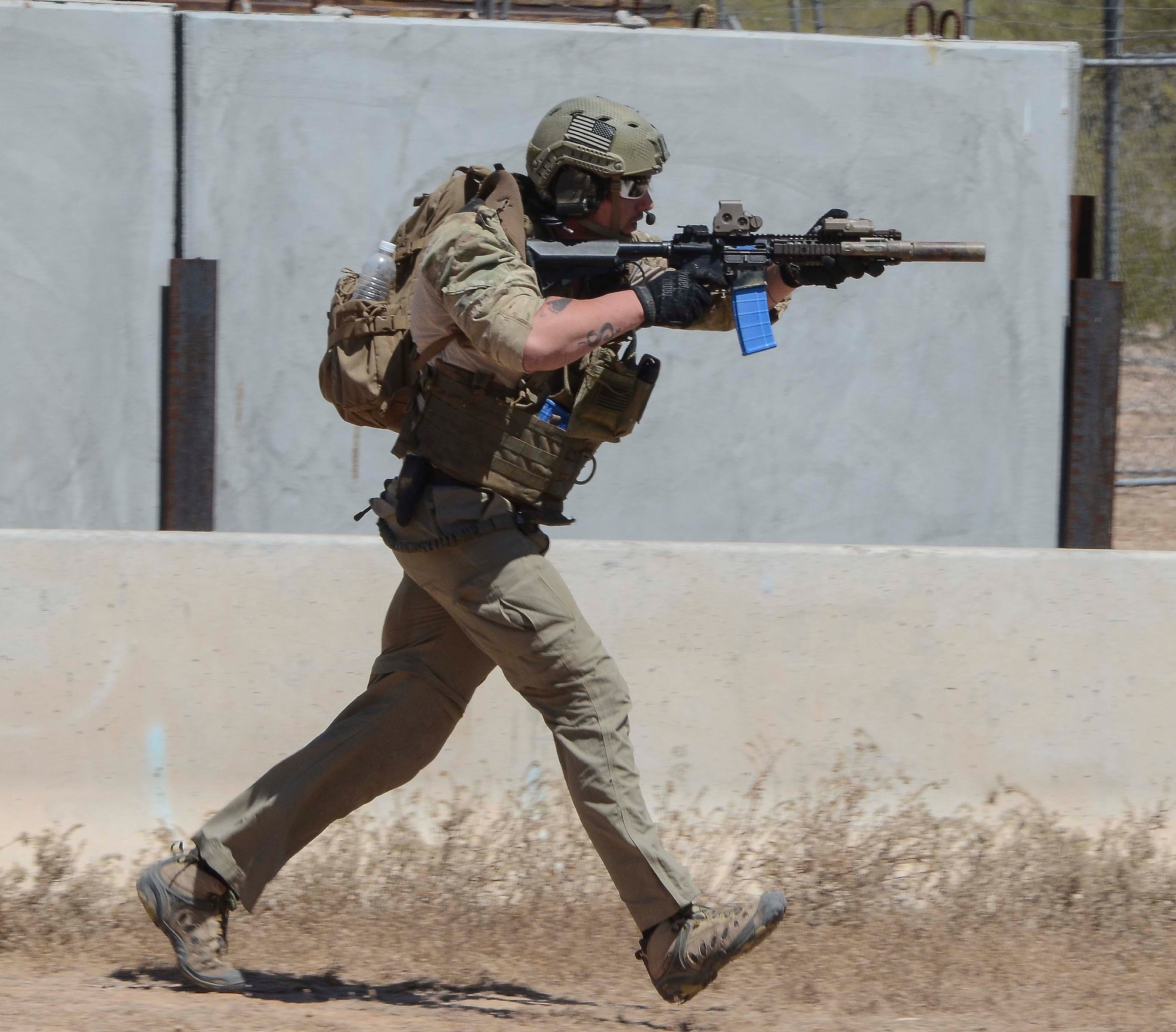 A member of a Multinational Combat Search and Rescue team sprints to a forward location during a training mission in Exercise ANGEL THUNDER on May 16, 2014 at the Florence Military Reservation, Ariz. ANGEL THUNDER 2014 is the largest and most realistic joint service, multinational, interagency combat search and rescue exercise designed to provide training for personnel recovery assets using a variety of scenarios to simulate deployment conditions and contingencies. Personnel recovery forces will train through the full spectrum of personnel recovery capabilities with ground recovery personnel, air assets, and interagency teams. (U.S. Air Force photo by Staff Sgt. Adam Grant/Released)