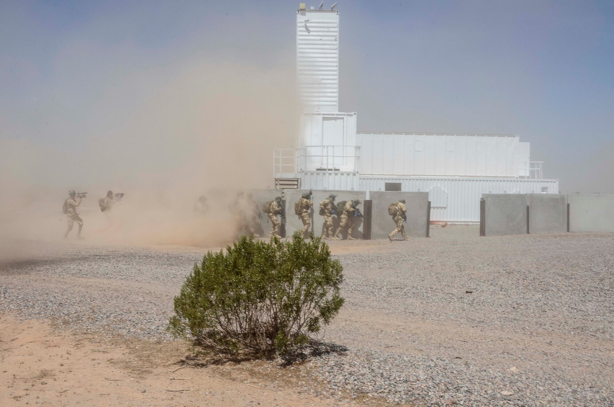 Members of a Multinational Combat Search and Rescue team prepare to enter a simulated urban compound during Exercise ANGEL THUNDER on May 16, 2014 at the Florence Military Reservation, Ariz. ANGEL THUNDER 2014 is the largest and most realistic joint service, multinational, interagency combat search and rescue exercise designed to provide training for personnel recovery assets using a variety of scenarios to simulate deployment conditions and contingencies. Personnel recovery forces will train through the full spectrum of personnel recovery capabilities with ground recovery personnel, air assets, and interagency teams. (U.S. Air Force photo by Staff Sgt. Adam Grant/Released)