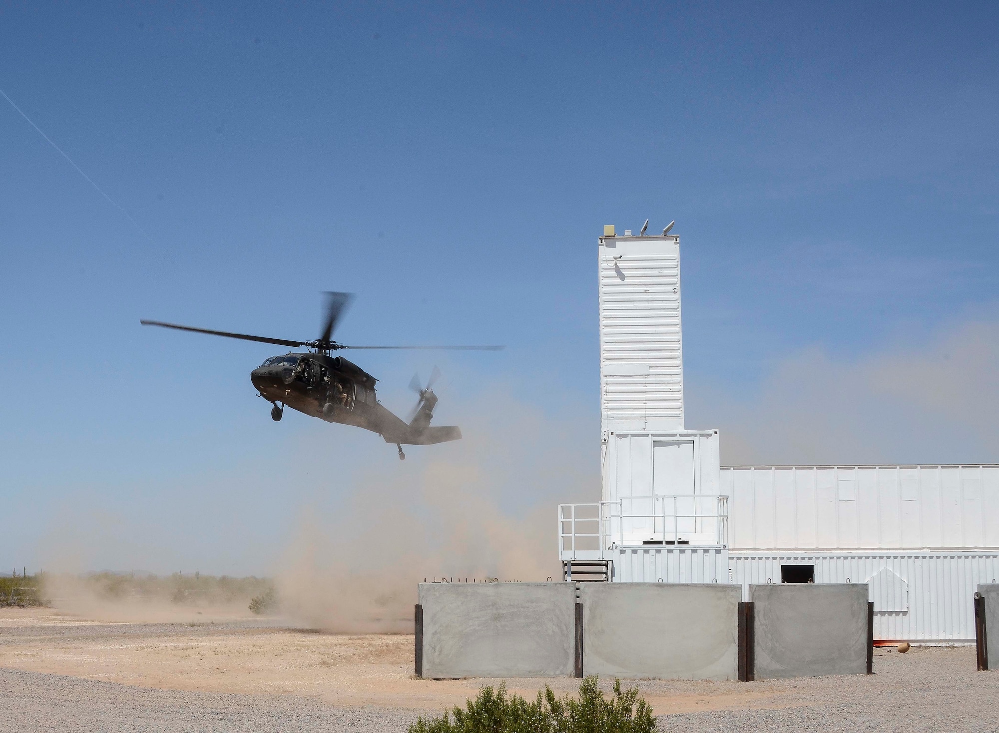 An Arizona Army National Guard 2-285 UH-60 Black Hawk helicopter prepares to land during a training mission in Exercise ANGEL THUNDER on May 16, 2014 at the Florence Military Reservation, Ariz. ANGEL THUNDER 2014 is the largest and most realistic joint service, multinational, interagency combat search and rescue exercise designed to provide training for personnel recovery assets using a variety of scenarios to simulate deployment conditions and contingencies. Personnel recovery forces will train through the full spectrum of personnel recovery capabilities with ground recovery personnel, air assets, and interagency teams. (U.S. Air Force photo by Staff Sgt. Adam Grant/Released)
