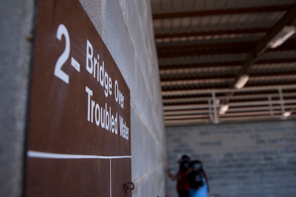 The 42nd Air Base Wing key spouses face the wall at Project X Leadership Reaction Course as their instructors read the exercise task, May 19, 2014, here. The course is meant to mentally and physically challenge teams, who must work together to accomplish various tasks. The spouses had to face the wall as part of the challenge was to plan without any predetermined preparation before the timer began. (U.S. Air Force photo by Staff Sgt. Natasha Stannard)