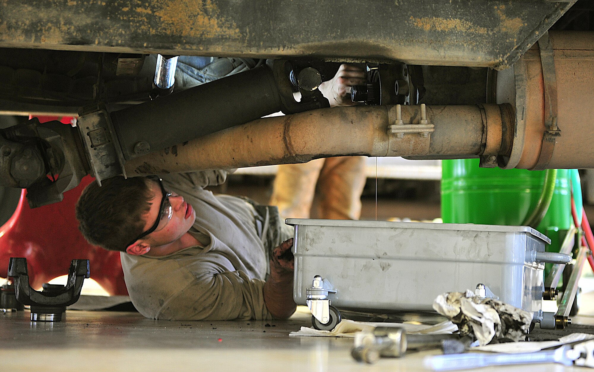 Airman 1st Class Jeffery Kesler, 5th Logistics Readiness Squadron Fire Truck Maintenance Team member, removes the rear housing cover on the transfer case of a P-30 utility fire truck at Minot Air Force Base, N.D., May 13. The team determines serviceability, overall condition of the trucks and need for repair by diagnostic, visual and audio examinations. (U.S. Air Force photo/Senior Airman Kristoffer Kaubisch)