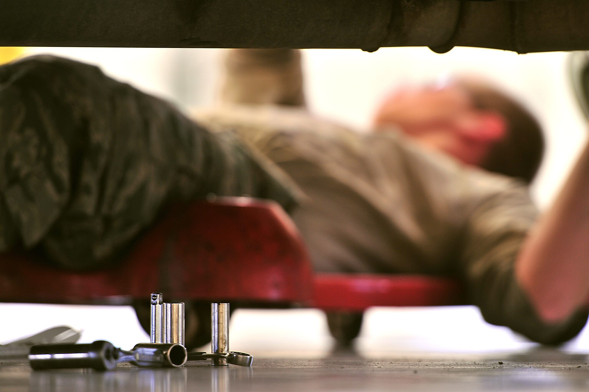 Airman 1st Class Jeffery Kesler, 5th Logistics Readiness Squadron Fire Truck Maintenance Team member, works under a P-30 utility fire truck at Minot Air Force Base, N.D., May 13. The fire truck maintenance team performs scheduled, unscheduled and preventative maintenance on the 5th Bomb Wing fire, crash and structural response trucks and equipment fleet. (U.S. Air Force photo/Senior Airman Kristoffer Kaubisch)